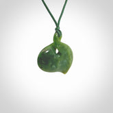 Hand carved New Zealand jade, single twist pendant. Maori pikorua pendant hand carved in New Zealand. Made by NZ Pacific, jade jewellery for sale online. One only hand made by Ross Crump.
